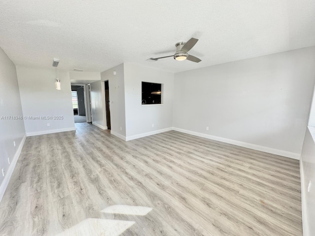 unfurnished room with ceiling fan, light hardwood / wood-style floors, and a textured ceiling