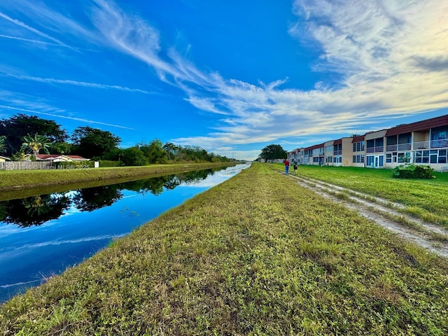 exterior space featuring a water view and a lawn