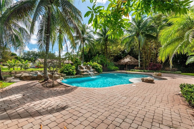 view of pool with a patio area and pool water feature