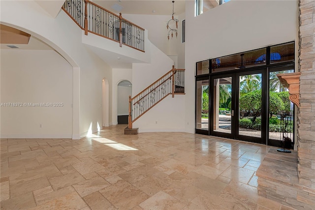 entrance foyer featuring french doors and a high ceiling