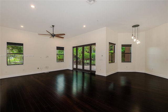 empty room with ceiling fan and dark wood-type flooring