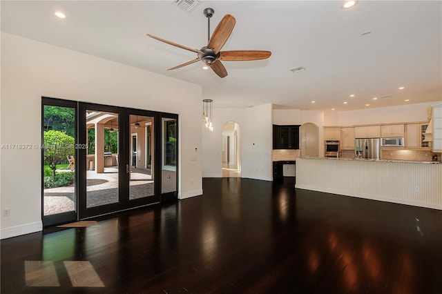 unfurnished living room featuring french doors, ceiling fan, and dark wood-type flooring