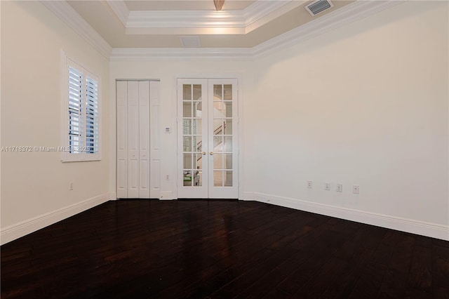 spare room featuring french doors, a tray ceiling, hardwood / wood-style flooring, and ornamental molding