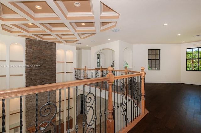 hallway with beamed ceiling, dark hardwood / wood-style floors, coffered ceiling, and ornamental molding