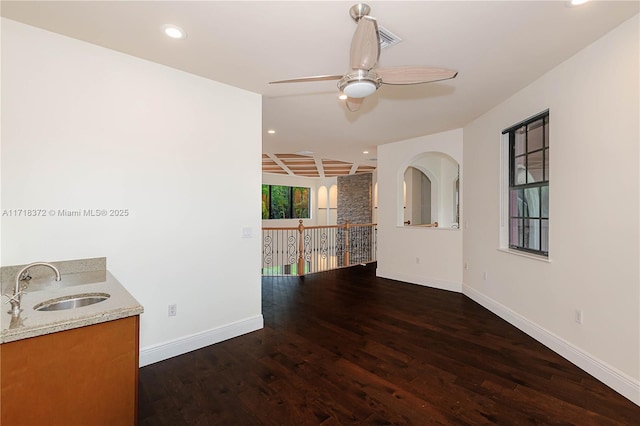 interior space with ceiling fan, dark hardwood / wood-style flooring, and sink