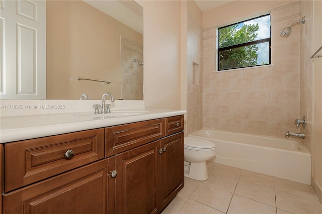 full bathroom with tile patterned flooring, vanity, tiled shower / bath combo, and toilet