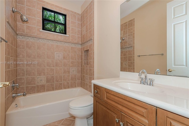 full bathroom with vanity, tile patterned flooring, tiled shower / bath, and toilet