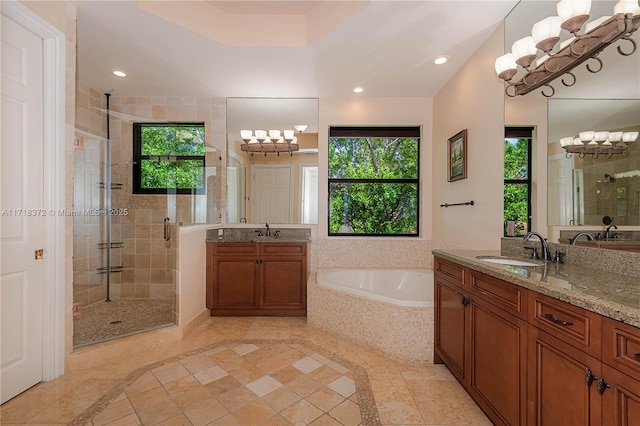 bathroom with vanity and independent shower and bath