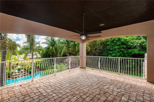 view of patio / terrace with ceiling fan and a balcony