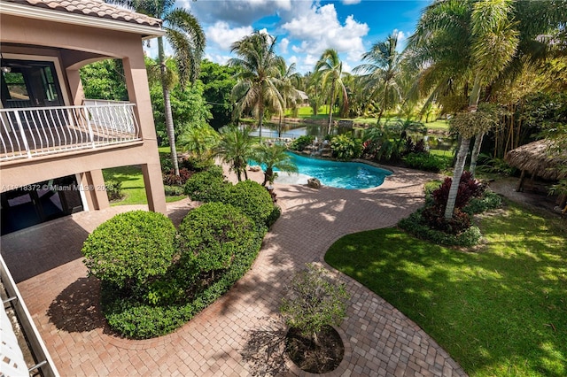 view of swimming pool featuring a water view and a patio