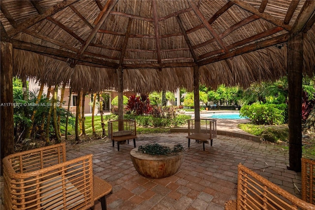 view of property's community featuring a gazebo, a patio area, and a swimming pool