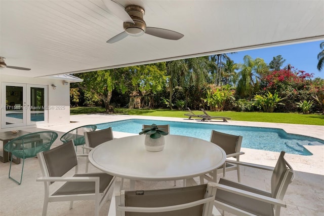 view of swimming pool with a lawn, ceiling fan, french doors, and a patio