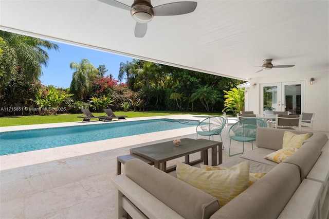 view of swimming pool with an outdoor living space, ceiling fan, a patio, and french doors