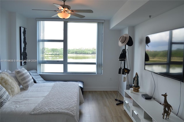 bedroom with light hardwood / wood-style flooring and ceiling fan