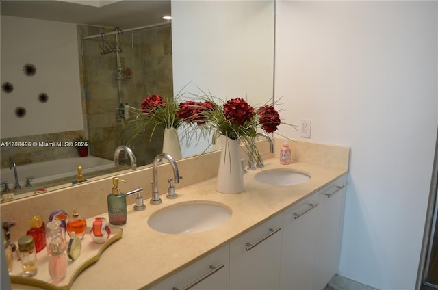 bathroom featuring a tile shower and vanity