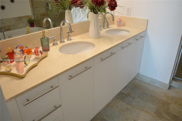 bathroom with vanity and a tub