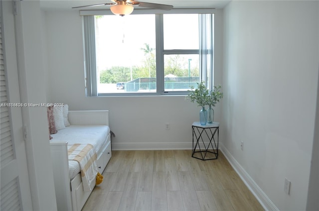 living area featuring ceiling fan and light hardwood / wood-style flooring