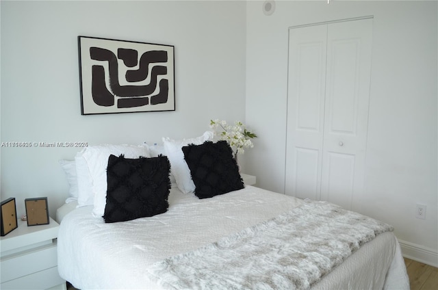 bedroom featuring a closet and wood-type flooring