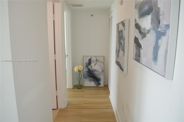 hallway with light hardwood / wood-style flooring