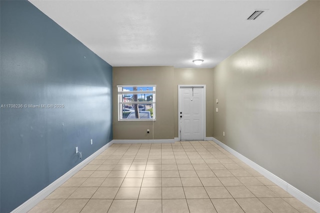 spare room with light tile patterned floors