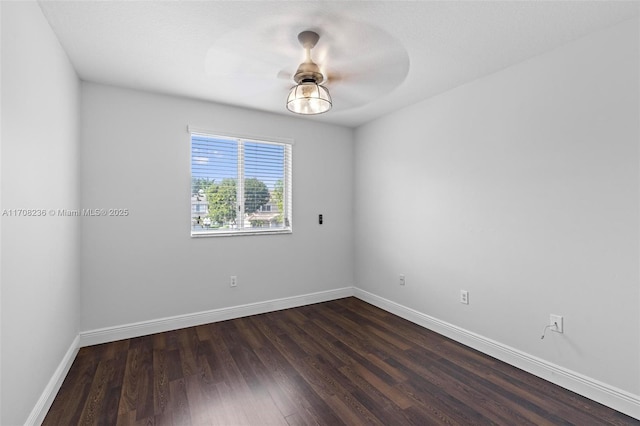 empty room featuring ceiling fan and dark wood-type flooring