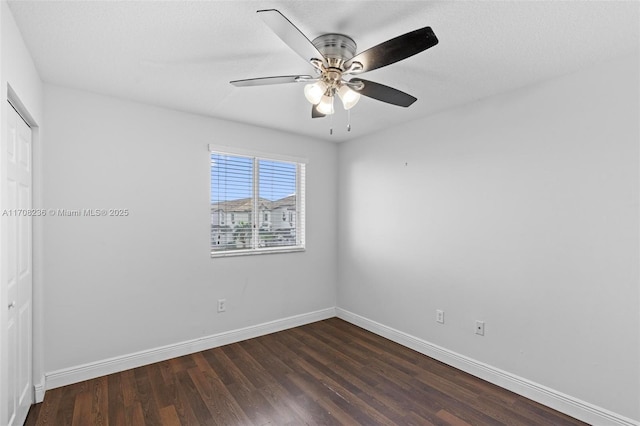 empty room with a textured ceiling, ceiling fan, and dark wood-type flooring