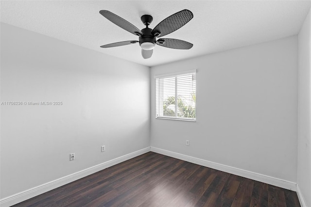 spare room with dark hardwood / wood-style floors and ceiling fan