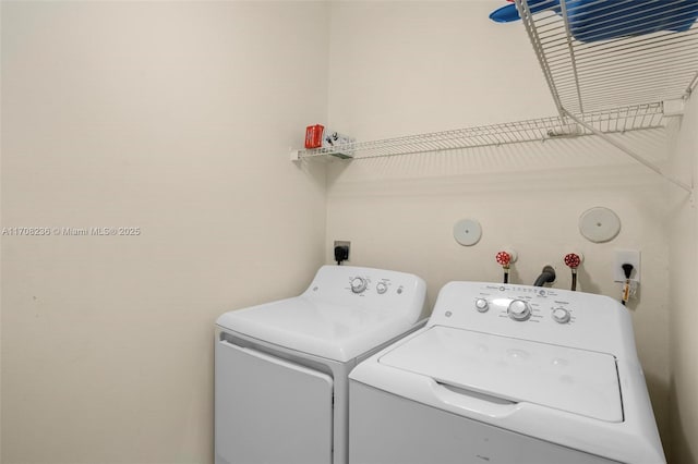 laundry area with independent washer and dryer