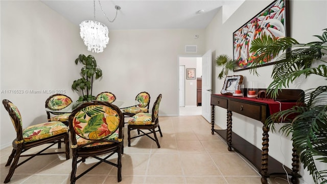 dining room featuring light tile patterned floors and an inviting chandelier