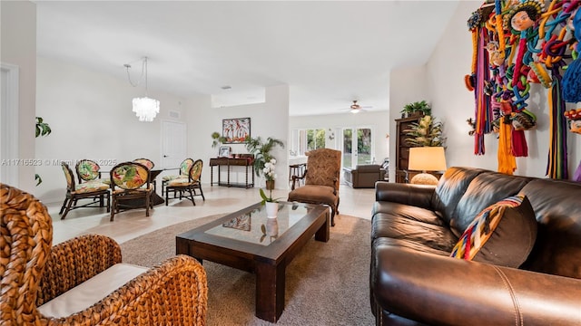 tiled living room featuring ceiling fan with notable chandelier