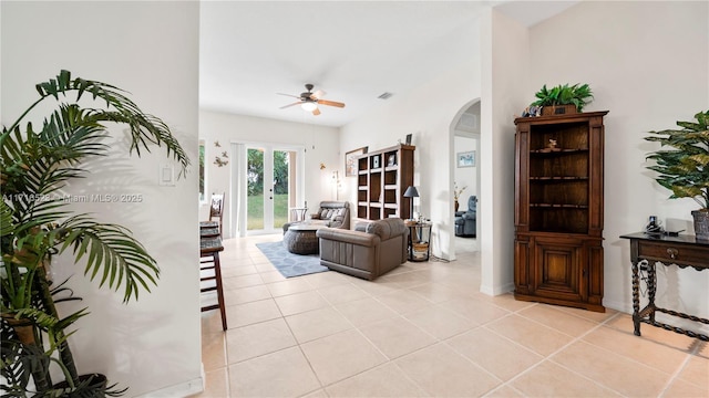 tiled living room featuring french doors and ceiling fan