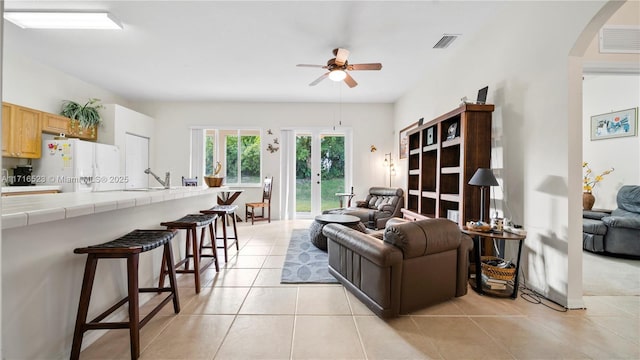 living room featuring light tile patterned flooring and ceiling fan