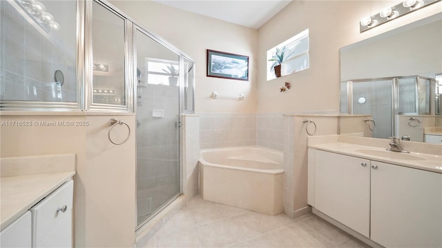 bathroom featuring tile patterned flooring, vanity, and separate shower and tub