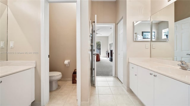 bathroom with tile patterned flooring, vanity, and toilet