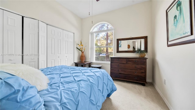 bedroom with light colored carpet and a closet