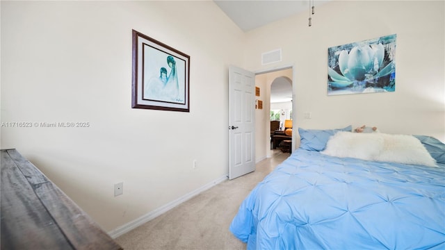 bedroom featuring light carpet