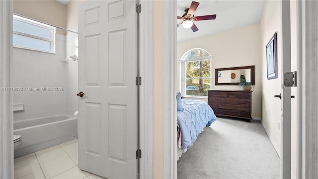 tiled bedroom featuring ceiling fan