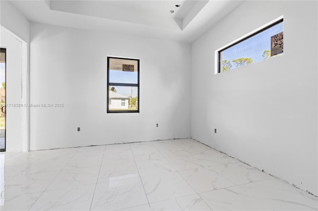 spare room featuring a tray ceiling