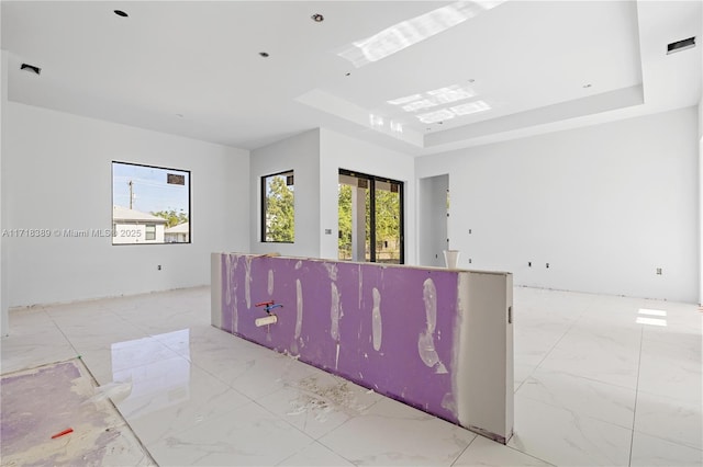 empty room featuring a raised ceiling