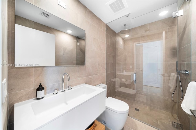 bathroom featuring vanity, decorative backsplash, toilet, tile walls, and an enclosed shower