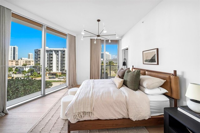 bedroom with access to outside, floor to ceiling windows, and multiple windows