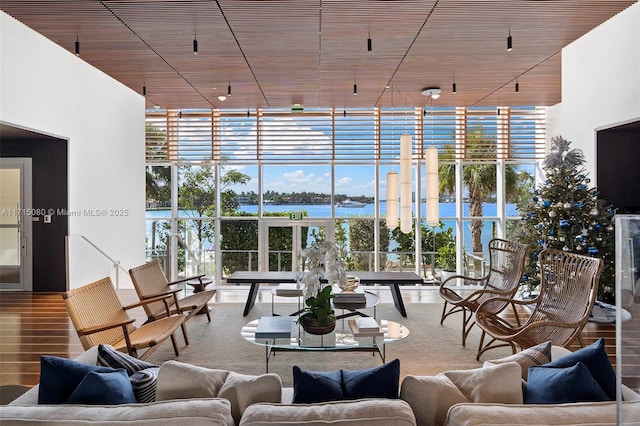 living room featuring hardwood / wood-style flooring, expansive windows, and wooden ceiling