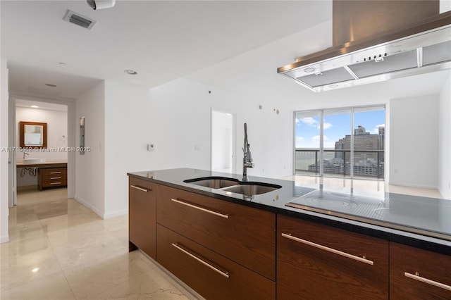 kitchen with sink, dark brown cabinets, cooktop, a wall of windows, and extractor fan