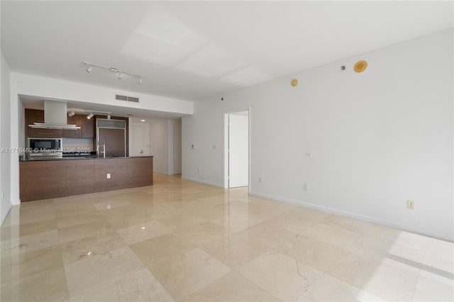 unfurnished living room featuring sink