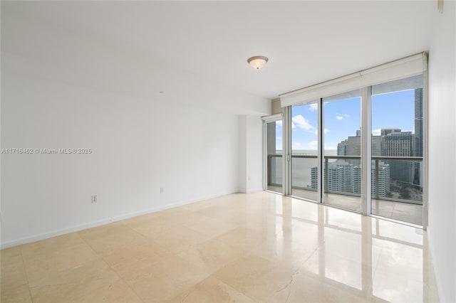 unfurnished room with floor to ceiling windows