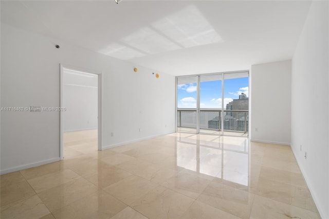 unfurnished room featuring expansive windows