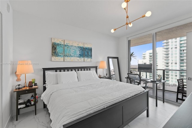 bedroom featuring a notable chandelier, floor to ceiling windows, and access to exterior