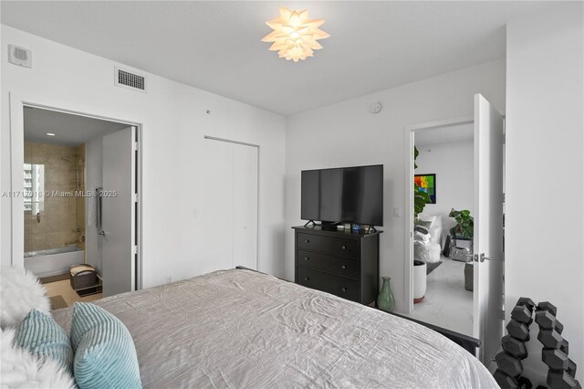 bedroom with a closet and ensuite bathroom