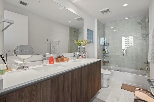 full bathroom with enclosed tub / shower combo, vanity, toilet, and tile patterned floors