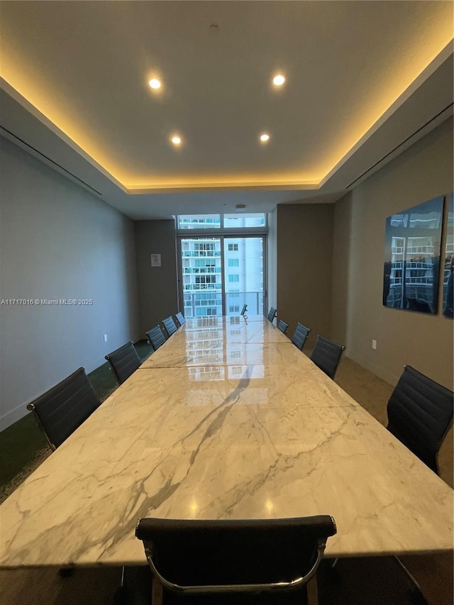 kitchen featuring a breakfast bar and a tray ceiling